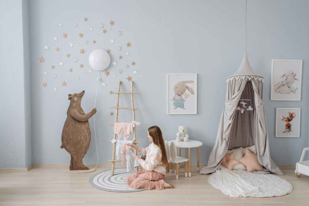 Woman arranging baby clothes in a beautifully decorated nursery with playful decor.